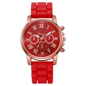 Detail of red silicone watch strap with grid texture and rose gold Geneva watch face
