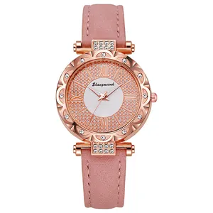 Close-up of pink leather watch strap with rose gold rhinestone bezel and Roman numerals