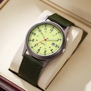 Close-up of military style quartz watch with green nylon strap and date display function