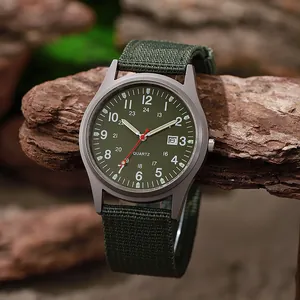 Military style quartz watch with green canvas strap and date display on a wood texture
