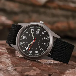 Military style quartz watch with black dial, nylon strap and date display on rock background