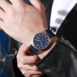 Close-up of military quartz watch with blue nylon strap and date display on male wrist