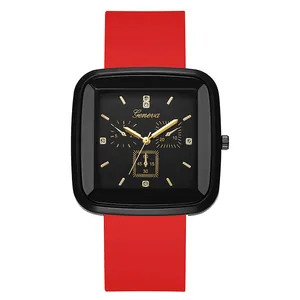 Detail of square black watch dial with Geneva logo, gold hands and red silicone strap