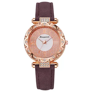 Detail of rose gold quartz watch with crystal bezel and purple leather strap