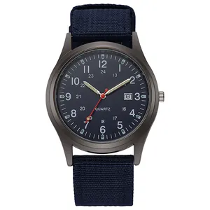 Detail of military quartz watch with navy blue nylon strap and 24-hour dial calendar