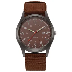 Macro detail of military quartz watch face with date window and brown canvas strap