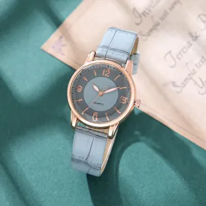 Women's quartz watch with blue leather strap and rose gold case on blue textile background