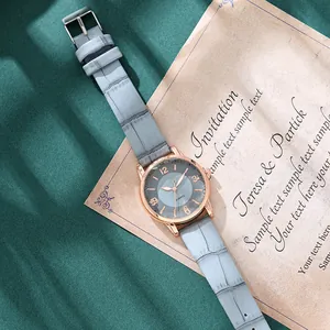 Elegant rose gold women's quartz watch with blue dial and crocodile texture leather strap