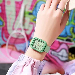 Macro detail of mint green square quartz watch with numeric dial and silicone strap