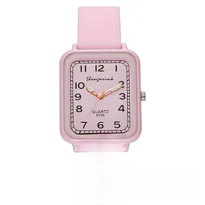 Detail of pink rectangular watch dial with clear Arabic numerals and silicone strap