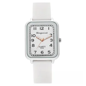 Detailed close-up of a white square quartz watch with a silver case and silicone strap