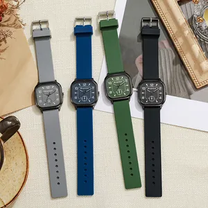 Macro view of four modern square quartz watches with matte silicone straps in various colors