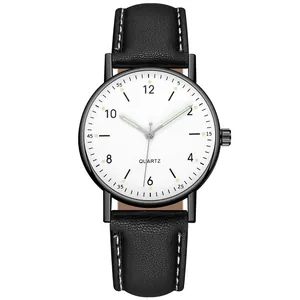 Detail of quartz watch dial with black leather strap and white contrast stitching