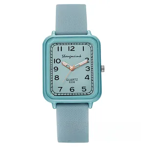 Detailed view of square light blue quartz watch with silicone strap and rose gold hands
