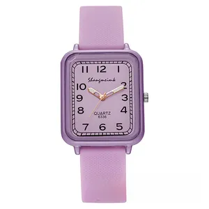 Detailed macro view of square purple watch face with rose gold hands and silicone strap