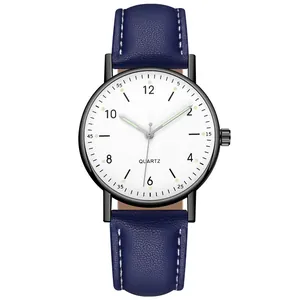 Detailed view of luminous hands on quartz watch with blue leather strap and white dial