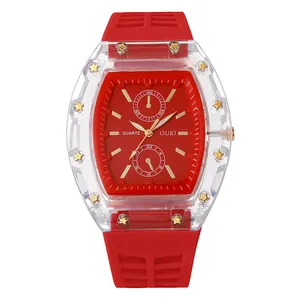 Gedetailleerde close-up van een transparant tonneau horloge met rode wijzerplaat en goud