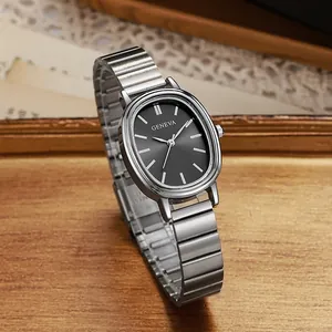 Elegant silver oval stainless steel watch for women with black dial on a wooden desk