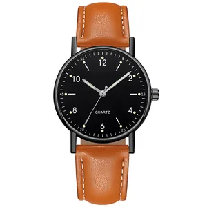 Detailed macro of simple quartz watch with black dial and brown leather stitched strap