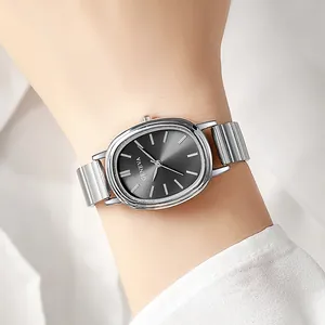 Detail of elegant silver oval watch with grey sunburst dial on stainless steel band