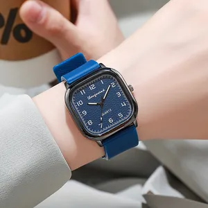 Macro detail of square quartz watch with blue grid dial and matching silicone strap