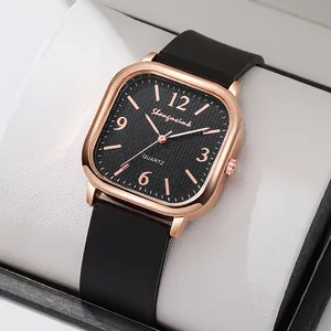 Detail of rose gold square watch with black mesh dial and minimalist numeric markers