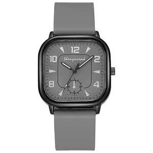 Detailed view of square black watch case with grey textured dial and silicone strap