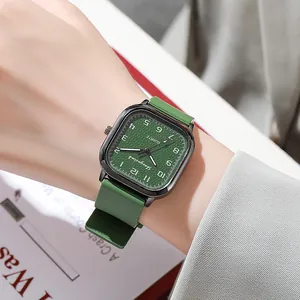 Elegant forest green square quartz watch with silicone strap on woman's wrist