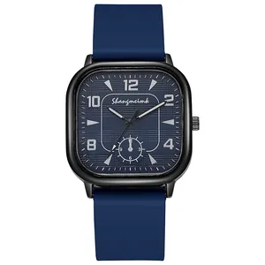 Detailed macro view of the square black watch case with blue silicone strap and dial