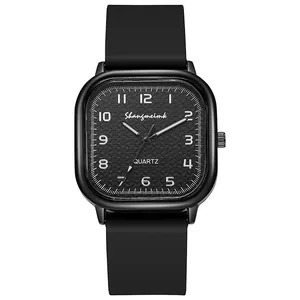 Macro shot of the square black metal case and matte silicone strap of this quartz watch