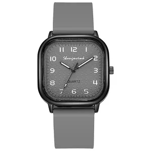 Detail view of the square quartz watch with a textured grey dial and silicone strap