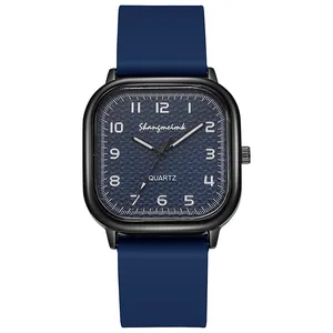 Detail of square quartz watch featuring textured blue dial and soft silicone strap