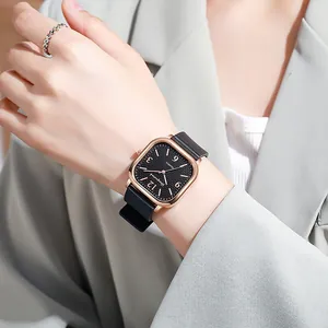 Elegant square ladies' quartz watch with black leather strap and wavy silver ring accessory