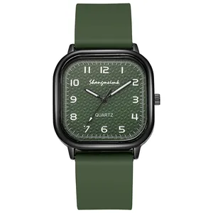 Detail of square olive green quartz watch with embossed dial and silicone strap
