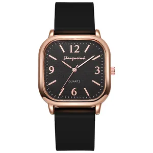 Macro view of square rose gold watch case with black textured dial and numeric indices