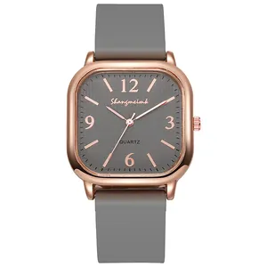 Detail view of square quartz watch with grey textured dial and rose gold metal casing