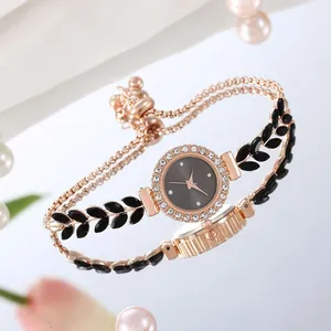 Detail of rose gold rhinestone watch with leaf-shaped links and adjustable sliding clasp