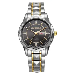 Detail of quartz watch with two-tone silver and gold steel strap and dual calendar display