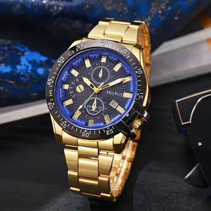 Close-up of golden quartz watch with blue chronograph dial and calendar display window