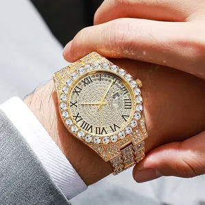 Luxury gold iced-out watch with rhinestones and Roman numerals on a businessman wrist