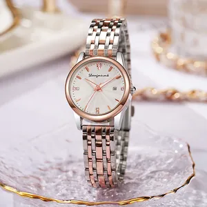Detailed macro view of radiant white dial with calendar window and rose gold steel strap