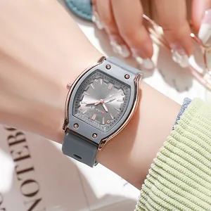 Close-up of a tonneau-shaped women watch with rose gold case and grey silicone strap