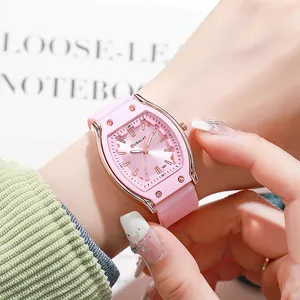 Close-up of pink tonneau quartz watch with silicone strap on a female wrist
