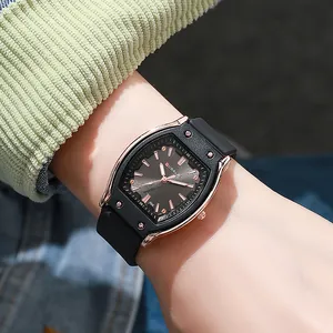 Macro view of tonneau watch face with rose gold frame and grey radial texture
