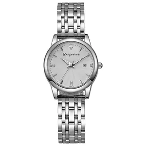 Detailed macro view of silver quartz watch with rhinestone markers and date display window