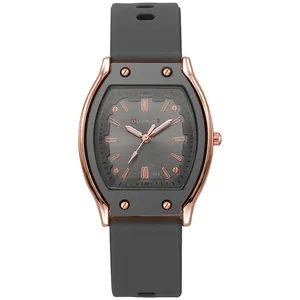 Detailed close-up of rose gold tonneau watch case with grey silicone strap and brushed dial