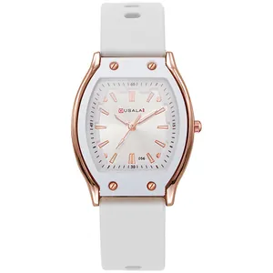 Close-up of white silicone strap and rose gold tonneau-shaped case of quartz watch