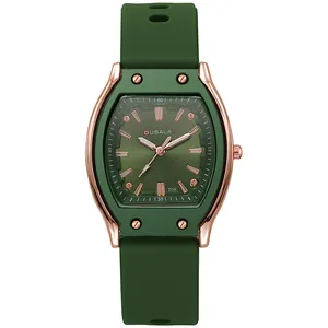 Macro detail of dark green tonneau watch face with rose gold metal bezel and silicone strap