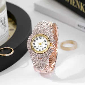 Detailed view of luxury rose gold quartz watch with full crystal inlay and white dial