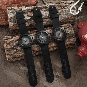 Three outdoor sport quartz watches with nylon straps displayed on a rustic bark background